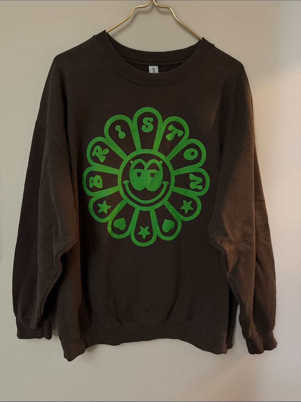 Briston Maroney Brown Crewneck Sweatshirt with Green Flower Smiley Graphic